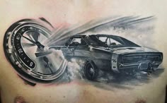 a man's chest with a car and tire tattoo on it