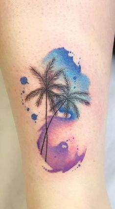 a watercolor painting style palm tree tattoo on the leg