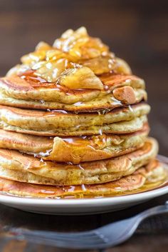 a stack of pancakes covered in syrup on a plate