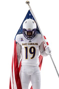 a football player is holding an american flag