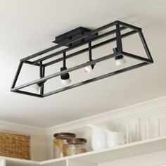 a kitchen light fixture hanging from the ceiling