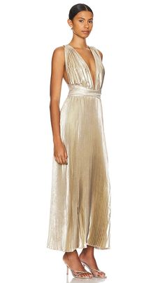 The L'IDEE Moderniste Gown is crafted from a lightweight, pleated fabric with a metallic finish. The gown features a plunging neckline, sleeveless design, and a hidden back zipper and tie closure. The gown is unlined. Available in sizes 6/XS, 8/S, 10/M, 12/L, and 14/XL. Made in Indonesia from 100% polyester. Hand wash. St Marteen, Gown Gold, Bridesmaid Dress Ideas, Dressy Dresses, Pleated Fabric, Gold Shimmer, Wedding Guest Dresses, Plunging Neckline, Tank Dress