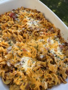 a casserole dish with meat, cheese and sauce in a large white bowl