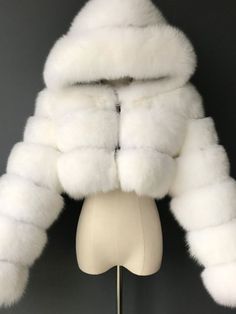 The "Faux Fur Hooded Bubble Coat" is the epitome of cozy, fashionable, and winter-ready outerwear. This stylish coat boasts a unique bubble hooded long sleeves open front design that not only catches the eye but also enhances warmth by trapping heat within its plush layers. Product Details Size Bust Shoulder Width Length Sleeve Length S 88 36 68 58 M 92 37 69 59 L 96 38 70 59 XL 100 39 71 59 XXL 104 40 72 60 XXXL 108 41 72 60 Short Fur Coat, Winter Faux Fur Coat, Faux Fox Fur Coat, Winter Coat Short, Cropped Faux Fur Coat, Faux Fur Hooded Coat, Bubble Coat, Faux Fur Cropped Jacket, Womens Faux Fur Coat