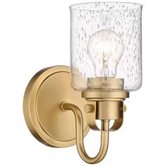 a light that is on the wall next to a glass shade holder with a bulb in it