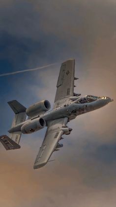 a fighter jet flying through a cloudy sky