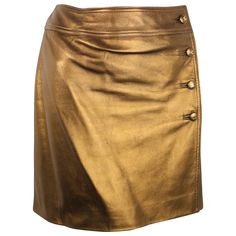 - Chanel bronze metallic lambskin leather wrap skirt from Fall 1996 collection. - Featuring four bronze metallic "CC" buttons down the side and a hook on the side closure. - Lined w CC lining. - Made in France. - Size 40. - Waist: 28 inches. Length: 15.5 inches. - 100% Lambskin. Double Lining: 100% Silk. Leather Wrap Skirt, Olive Skirt, Chanel Skirt, Leather Skirt Outfit, Chanel Brand, Wrap Skirts, Button Up Skirts, Brown Skirt, Metallic Skirt