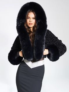 Elevate your style with our high quality Kali Cropped Faux Fur Jacket, a lavish and chic wardrobe essential. Crafted from luxe faux fur, this cropped jacket boasts a soft feel and features an attached hood adorned with a puffy fur trim. Fully lined for comfort, Kali adds a touch of glamour to any special occasion or everyday ensemble. Versatile in black, and also available in white, this jacket promises to be the perfect finishing touch for a sophisticated and stylish look. Why buy real fur when