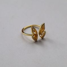 Discover our graceful ring with an open butterfly design. The size is adjustable and the piece of jewelry is available in elegant gold. Made from high quality 925 sterling silver, this ring adds subtle elegance and timeless sophistication to your look. Space Rings, Subtle Elegance, Butterfly Ring, Negative Space, Butterfly Design, Rings Statement, Statement Rings, Jewelry Rings, Bathing Beauties