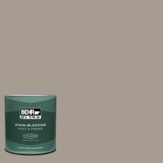 a can of behrut ultra stain - blocking paint and primer on a gray background