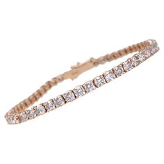 This exquisite bracelet is crafted from 14 kt rose gold and adorned with 7.23 carats of natural pink diamonds. Featuring 53 meticulously set diamonds, the bracelet radiates a delicate pink hue that exudes elegance and charm. Certified by GWLab for quality and authenticity, this piece is a perfect blend of luxury and sophistication, making it an enchanting addition to any jewelry collection. Side Stones: ___________ Natural Diamonds Cut: Round Brilliant Carat: 7.23 cttw / 53 stones Color: Pink Clarity: VS2-I1 Metal weight: 8.49 gr. Size: 17.5 cm Item ships from Israeli Diamonds Exchange, customers are responsible for any local customs or VAT fees that might apply to the purchase. **Import duties and taxes are not included in the item price. The Import process is very simple as the shipping 14k Rose Gold Bracelet, Diamond Mines, Vintage Tennis, Pink Diamonds, Modern Bracelets, Rose Gold Bracelet, Tennis Bracelet Diamond, Emerald Cut Diamonds, Pink Diamond