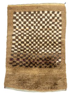 an area rug with brown and white squares on the top, in front of a white background