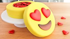 two yellow boxes with red hearts in them sitting on a table next to each other