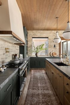 a kitchen with green cabinets and an area rug