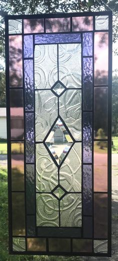 a stained glass window sitting in the grass