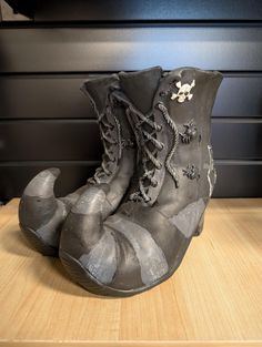 an old pair of shoes sitting on top of a wooden table