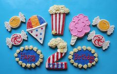 decorated cookies are arranged in the shape of fireworks, popcorn, hats and stars on a blue background