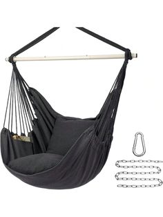 a black hammock hanging from the side with chains and hooks attached to it