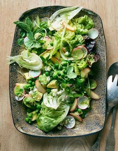 a salad with lettuce, radishes and other vegetables on a plate