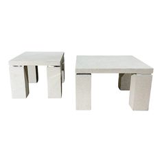 two white tables sitting next to each other