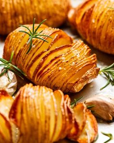 baked potatoes with rosemary sprigs and garlic on the side, ready to be eaten