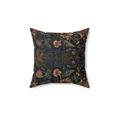 a black and brown pillow with flowers on it