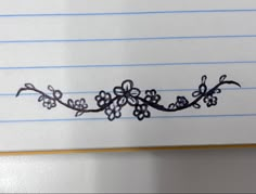 a piece of paper that has some kind of flower design on the side of it