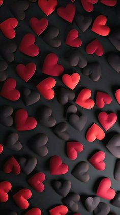 many red and gray hearts are arranged in the shape of heart shapes on a black background