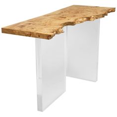 a wooden table with clear acrylic legs and a wood slab at the top