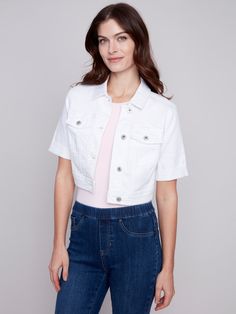 Complete your summer outfits with this cropped twill jean jacket for women in White. A button front, shirt collar and short folded hem sleeves turn this jacket into a versatile must-have item this season. Protect your shoulders from the sun and add that special finishing touch to your outfit. Pair it with other jeans, shorts or twill pants. Bring it with you wherever you go. The possibilities are endless. Cropped jean jacket Button closure 2 front pockets Short sleeves with folded hem This white White Crop Jean Jacket Outfit, White Cropped Jean Jacket Outfits, Casual White Cropped Denim Jacket, White Denim Cropped Jeans With Pockets, Trendy White Cropped Denim Jacket, Denim Editorial, Mini Jumpsuit, Short Denim, Womens Cropped Jeans