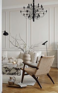 a living room filled with furniture and a chandelier