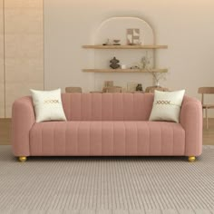 a living room with a pink couch and two white pillows on the armrests