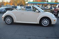 a small white car parked in a parking lot