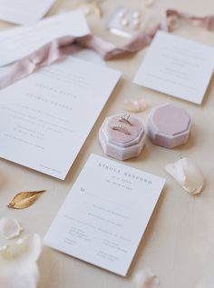 the wedding stationery is laid out on the table