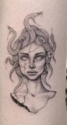 a woman's face with a snake on her head