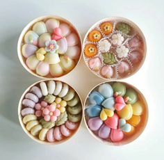 four bowls filled with different types of candies