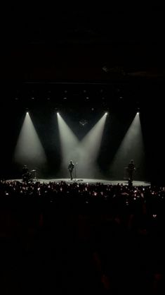 the stage is lit up with three spotlights