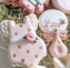 cookies decorated with pink and white icing on top of a table