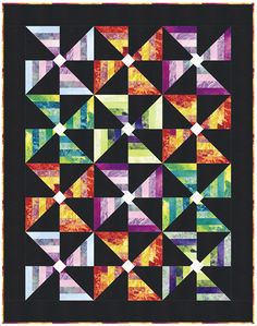 an abstract quilt with many different colors and shapes on it, including triangles in the center