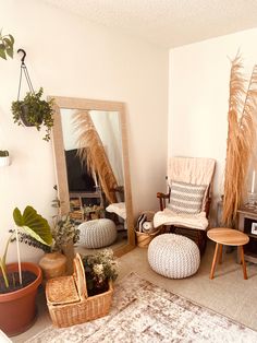 a living room filled with lots of furniture and plants on top of carpeted flooring