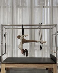 a woman doing aerial acrobatics on a wooden table