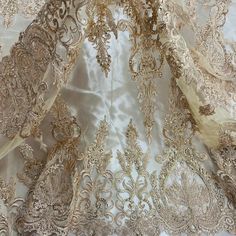 Turn heads with this exquisite Beaded & Corded Bridal Lace Fabric Embroidered on 100% Polyester Net Mesh. Beautifully crafted and adorned with pearls, sequins and beads, this special fabric is perfect for adding a glamorous and luxurious touch to your wedding dress, evening gown, quinceanera dress and any other dance costumes or special occasion outfits. You'll feel like a princess when you step out wearing this amazing Corded Couture Lace, Beaded Couture Lace, Beaded Bridal Lace, Beaded Evening Gold Embellished Organza For Embroidered Fabric, Gold Embellished Embroidered Organza Fabric, Fitted Embroidered Lace For Festive Occasions, Festive Fitted Embroidered Lace, Elegant Embroidered Lace For Festive Season, Gold Floral Embroidered Fabric For Ceremony, Elegant Gold Embroidered Fabric For Ceremonies, Gold Embroidered Fabric For Formal Occasions, Elegant Gold Resham Embroidered Fabric