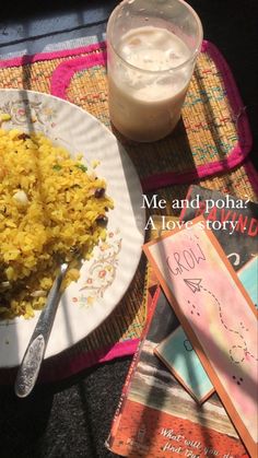 rice and other food on a plate next to a glass of milk with a spoon