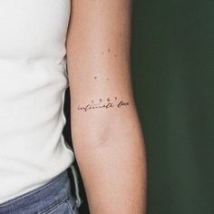 a woman with a small tattoo on her arm