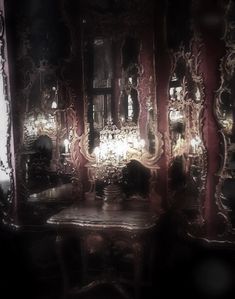 an ornately decorated table and mirror in a dark room