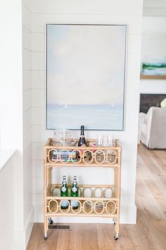 a bar cart with bottles and glasses on it