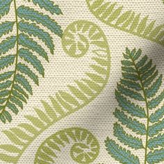 a green and white fabric with leaf designs on the front, side and back sides