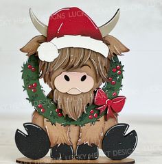 a christmas card with a cow wearing a wreath