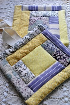 a close up of two pieces of fabric on top of a lace table cloth covered table