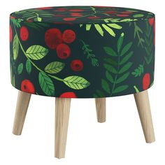 a small round stool with red berries and leaves on black fabric, sitting on wooden legs